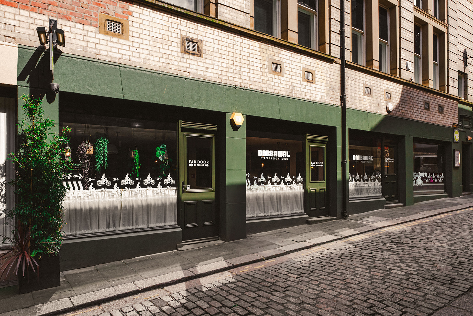 Front façade of Dabbawal High Bridge Indian street food kitchen on cobbled street in Newcastle