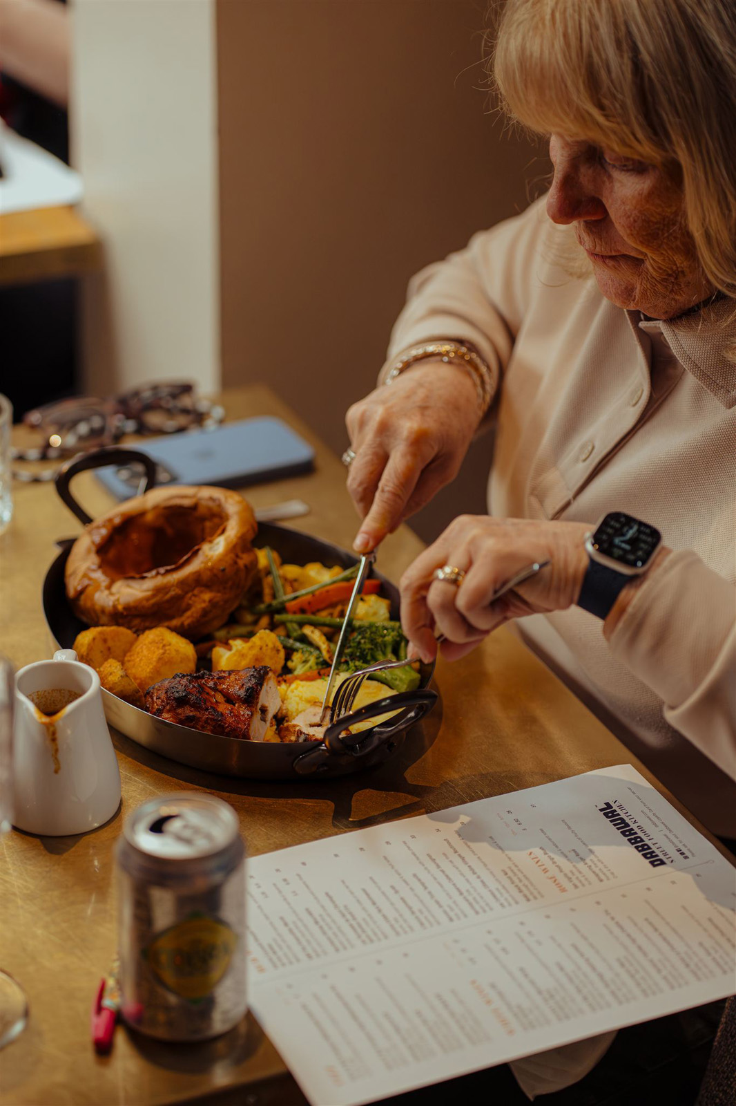 woman enjoying a meal at dabbawal indian restaurant, newcastle